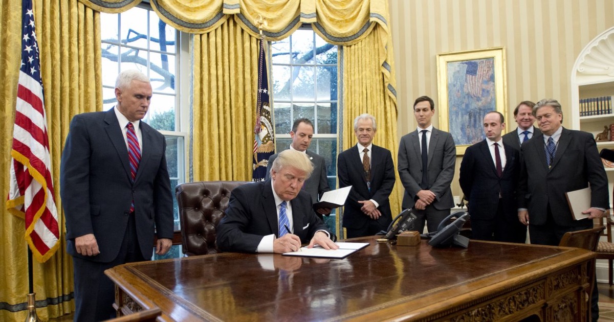 President Donald Trump signs the first of three Executive Orders in the Oval Office of the White House in Washington, D.C on Monday, Jan. 23, 2017. (Ron Sachs - Pool/Getty Images)