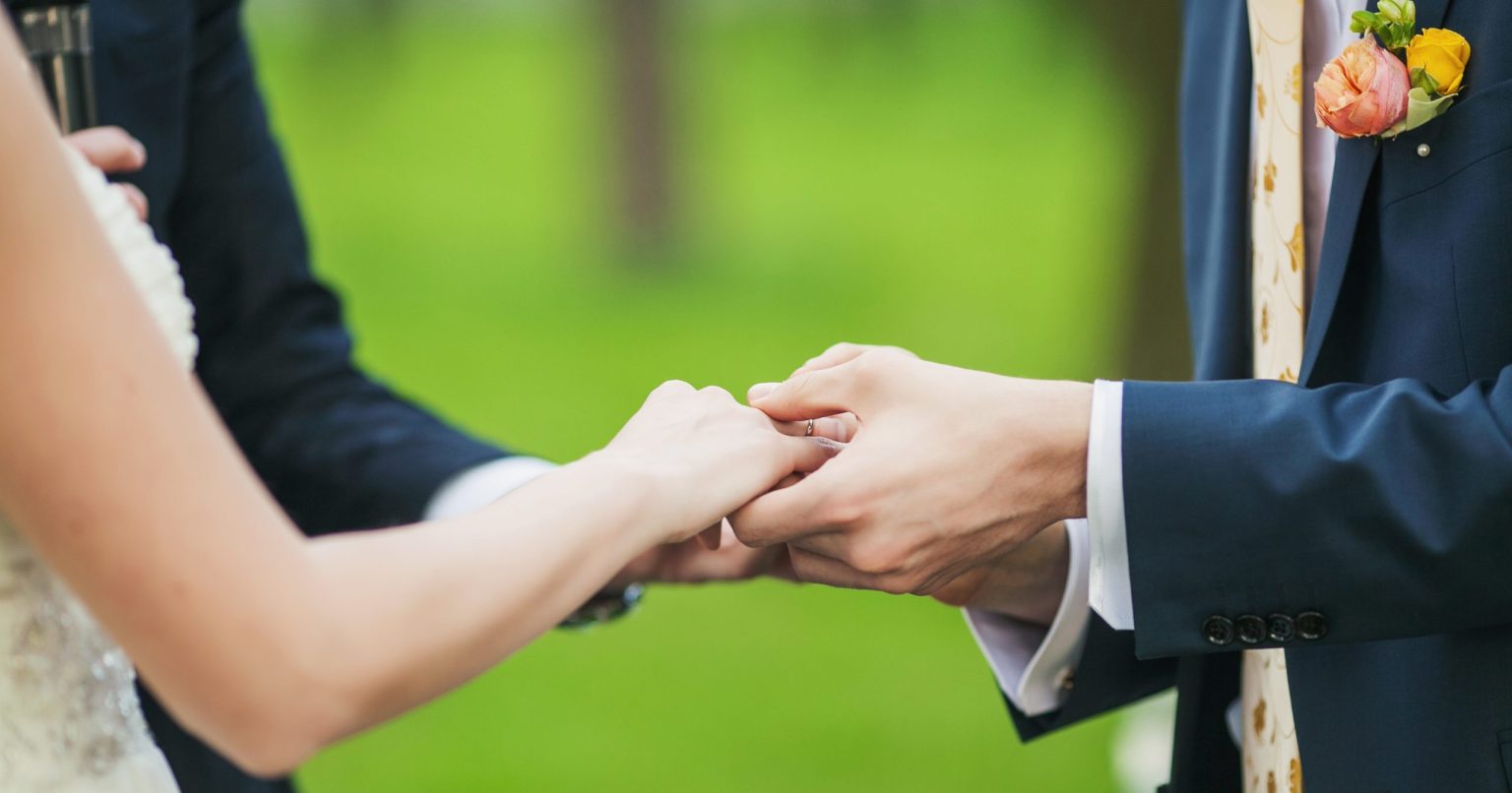 Married Couple Holding Hands at Wedding