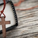 Religious_Liberty-Bible-Cross-shutterstock_132553313 - California Family Council Small cross necklace/rosary on the edge of a Bible
