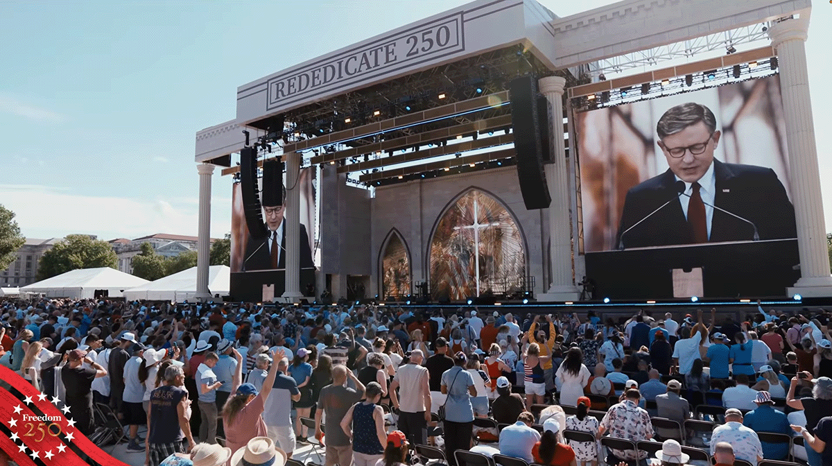2026-rededication - California Family Council - California Family Council Outdoor concert or ceremony with a large stage and screens; a man speaks at a podium while a crowd listens, banner reads REDEDICATE 250, patriotic badge at left corner.