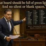 Senator Steve Padilla speaks at a wooden podium in a ornate senate chamber, pointing to a large vote-board of names and a bold quote above it: 'That board should be full of green lights. And no silent or blank spaces.'